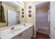 Bright bathroom features double sink vanity with white cabinets and a tub with shower at 616 Piping Rock Pt, Lawrenceville, GA 30043
