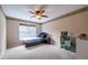 Cozy bedroom with neutral colors, a ceiling fan, a window, and built-in storage at 616 Piping Rock Pt, Lawrenceville, GA 30043
