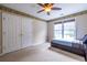 Bedroom showcasing a ceiling fan, built-in storage, neutral carpet, and natural light at 616 Piping Rock Pt, Lawrenceville, GA 30043