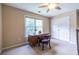 Bedroom with a desk area, ceiling fan, and closet doors at 616 Piping Rock Pt, Lawrenceville, GA 30043
