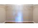 Empty closet showing built-in shelves, hardwood floor, and neutral paint at 616 Piping Rock Pt, Lawrenceville, GA 30043