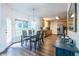 Cozy dining area with natural light, hardwood floors, seating for four, and direct access to the kitchen and outdoor spaces at 616 Piping Rock Pt, Lawrenceville, GA 30043