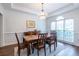 Elegant dining room featuring a chandelier and large windows for natural light at 616 Piping Rock Pt, Lawrenceville, GA 30043