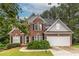 Charming two-story brick home with well-manicured lawn and attached two car garage at 616 Piping Rock Pt, Lawrenceville, GA 30043