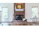 Charming brick fireplace with a mantle and hearth, complemented by hardwood floors and windows to enjoy the view at 616 Piping Rock Pt, Lawrenceville, GA 30043