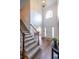 Inviting foyer with hardwood floors, staircase, and plenty of natural light from the large arched window above the front door at 616 Piping Rock Pt, Lawrenceville, GA 30043