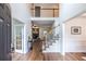Welcoming foyer with staircase, hardwood floors, and views into the living spaces at 616 Piping Rock Pt, Lawrenceville, GA 30043