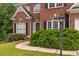 Inviting front entrance with brick facade, well-maintained landscaping and a lamp post at 616 Piping Rock Pt, Lawrenceville, GA 30043