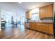 Open concept kitchen features hardwood floors, wood cabinets, stainless appliances, and easy access to living and dining areas at 616 Piping Rock Pt, Lawrenceville, GA 30043