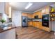 Bright kitchen boasts stainless appliances, hardwood floors, light wood cabinets, and a convenient double oven, perfect for cooking at 616 Piping Rock Pt, Lawrenceville, GA 30043