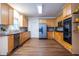Well-lit kitchen with stainless steel appliances, hardwood floors, wood cabinets, and ample counter space, ready for culinary creations at 616 Piping Rock Pt, Lawrenceville, GA 30043