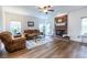 Inviting living room featuring a cozy brick fireplace and gleaming hardwood floors at 616 Piping Rock Pt, Lawrenceville, GA 30043