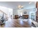 Spacious living room with hardwood floors, cozy seating, a ceiling fan, and a staircase, ideal for relaxation and entertainment at 616 Piping Rock Pt, Lawrenceville, GA 30043