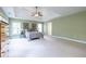 Large main bedroom with a king bed, tray ceiling, and walls painted a neutral green at 616 Piping Rock Pt, Lawrenceville, GA 30043