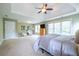 Expansive main bedroom featuring a king bed, tray ceiling, and large windows for natural light at 616 Piping Rock Pt, Lawrenceville, GA 30043