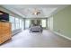 Large main bedroom with a tray ceiling, plush carpet, and many windows at 616 Piping Rock Pt, Lawrenceville, GA 30043