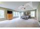 Expansive main bedroom with tray ceiling and natural light from large windows at 616 Piping Rock Pt, Lawrenceville, GA 30043