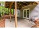 Open patio space with gray siding on home and wooded area in the background at 616 Piping Rock Pt, Lawrenceville, GA 30043