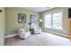 Comfortable sitting area with two armchairs and a window in a naturally lit room at 616 Piping Rock Pt, Lawrenceville, GA 30043