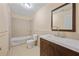 Bathroom featuring a tub, toilet, and vanity with a mirror, offering a clean and functional space at 773 Van Briggle Path, Sugar Hill, GA 30518