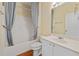 Bathroom with white vanity, and a tub/shower combo with blue striped curtains at 773 Van Briggle Path, Sugar Hill, GA 30518