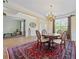 Elegant dining area with hardwood floors, a chandelier, and large windows at 773 Van Briggle Path, Sugar Hill, GA 30518