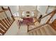 Open foyer featuring staircase, hardwood floors and view into the living room with fireplace at 773 Van Briggle Path, Sugar Hill, GA 30518