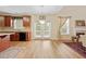Modern kitchen with granite countertops, stainless steel appliances, and hardwood floors at 773 Van Briggle Path, Sugar Hill, GA 30518