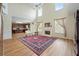 Spacious living room with tall ceilings, a fireplace, and hardwood floors at 773 Van Briggle Path, Sugar Hill, GA 30518