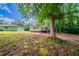 A quaint backyard with a small deck, backing up to a lush forest at 10150 Puckett St, Covington, GA 30014