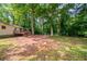 A spacious backyard features a wooden deck and beautiful green trees at 10150 Puckett St, Covington, GA 30014