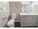 Bathroom with gray vanity, white countertop, black floor tile and updated fixtures at 10150 Puckett St, Covington, GA 30014