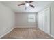 Bedroom featuring two closets, neutral carpet, and a bright window with white trim at 10150 Puckett St, Covington, GA 30014