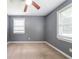 Bedroom with gray walls, neutral carpet, white trim, ceiling fan and bright windows at 10150 Puckett St, Covington, GA 30014