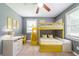 Playful bedroom featuring unique yellow bunk beds, cheerful decor, a desk, and a window for natural light at 10150 Puckett St, Covington, GA 30014