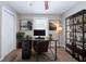 Comfortable home office with a modern desk, shelving, a neutral color scheme, and a window for natural light at 10150 Puckett St, Covington, GA 30014