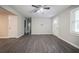 Open-concept living space featuring neutral paint, modern ceiling fan, stylish floors, and natural light at 10150 Puckett St, Covington, GA 30014