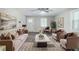 Cozy living room featuring neutral paint, ample seating, decorative art, a ceiling fan, and natural light at 10150 Puckett St, Covington, GA 30014