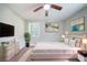 Serene main bedroom featuring neutral decor, plush bedding, a dresser, and a window with natural light at 10150 Puckett St, Covington, GA 30014
