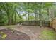 Wooden fence encloses backyard with mature trees and room for entertaining at 161 Stoneforest Dr, Woodstock, GA 30189