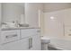 Bathroom featuring modern vanity with granite countertop and white tub/shower combo at 161 Stoneforest Dr, Woodstock, GA 30189