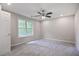 Comfortable bedroom with a ceiling fan and a large window, offering a peaceful retreat for rest and relaxation at 161 Stoneforest Dr, Woodstock, GA 30189