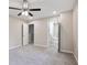 Large bedroom featuring a ceiling fan, plush carpeting, and access to the bathroom and additional room at 161 Stoneforest Dr, Woodstock, GA 30189
