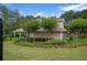 Well-maintained home with landscaped yard, flowering trees, and a covered patio at 161 Stoneforest Dr, Woodstock, GA 30189