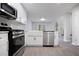 Well-equipped kitchen features stainless steel appliances and a modern aesthetic with seamless flow into the living space at 161 Stoneforest Dr, Woodstock, GA 30189