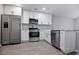 Modern kitchen with stainless steel appliances, white cabinets, and sleek countertops, perfect for culinary enthusiasts at 161 Stoneforest Dr, Woodstock, GA 30189