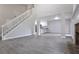 Open-concept living area featuring a staircase, a fireplace, and seamless flow to the modern kitchen at 161 Stoneforest Dr, Woodstock, GA 30189