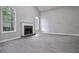 Bright living room features a fireplace and large arched windows, offering a cozy and inviting atmosphere at 161 Stoneforest Dr, Woodstock, GA 30189