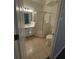 Bright bathroom featuring tiled floors, a sink with vanity, and a glass enclosed shower at 101 Dancing Fox Rd, Decatur, GA 30032