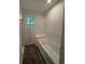 Bright bathroom featuring a tub with white tile surround and a window providing natural light at 101 Dancing Fox Rd, Decatur, GA 30032